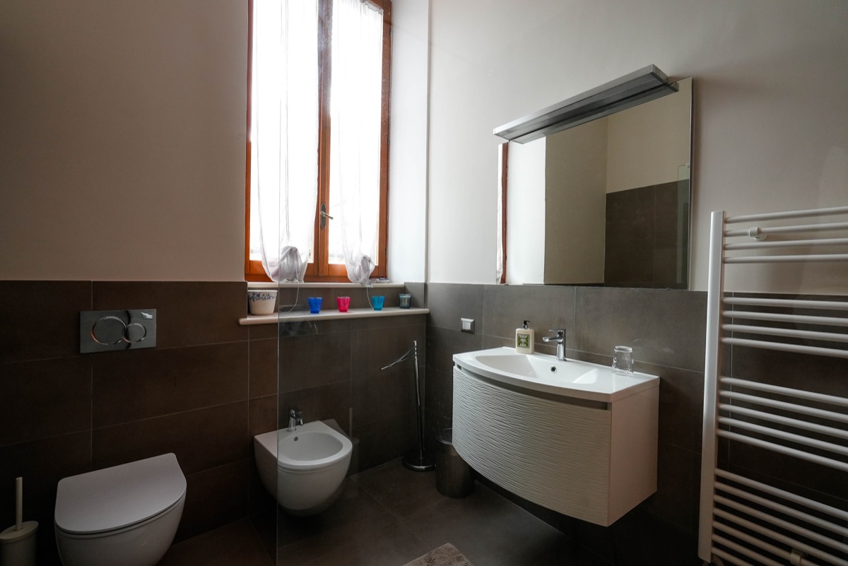Bagno con lavandino, finestra e specchio